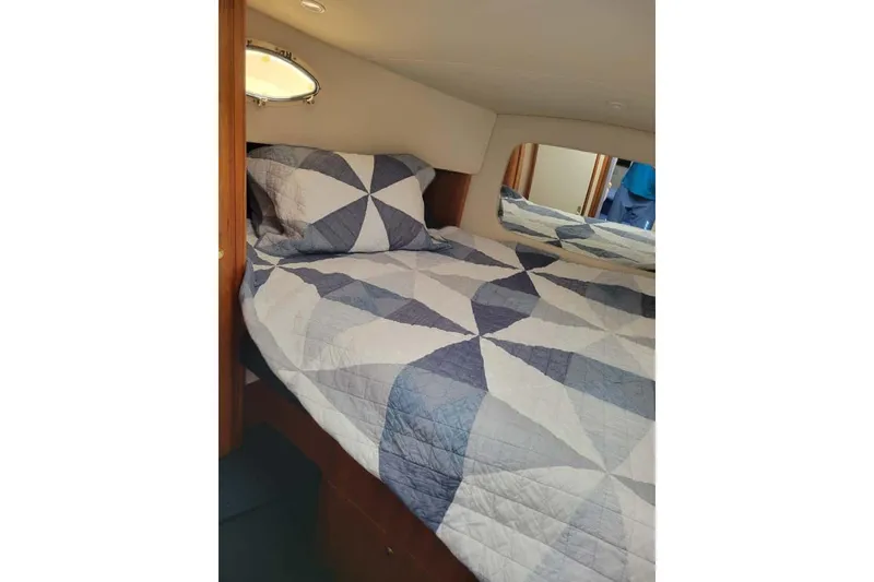 Slide: The Image of Interior of 1999 Silverton 392 Motor Yacht with beige seating and wooden accents. - 12