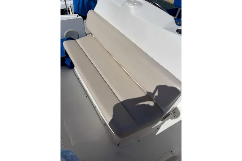 Slide: The Image of 1999 Silverton 392 Motor Yacht with blue and beige striped seating on deck. - 6