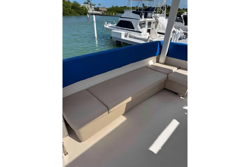 Slide: The Image of 1999 Silverton 392 Motor Yacht beige seating area with shadow on deck. - 8