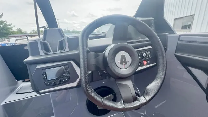 Slide: The Image of 2024 Axis A245 boat dashboard with steering wheel and control panel. - 12
