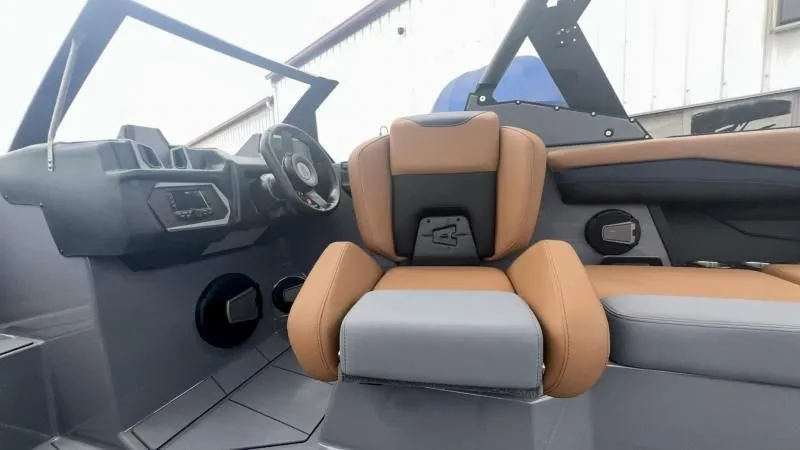 Slide: The Image of 2024 Axis A245 boat interior with tan and gray seating, modern dashboard, and steering wheel. - 14