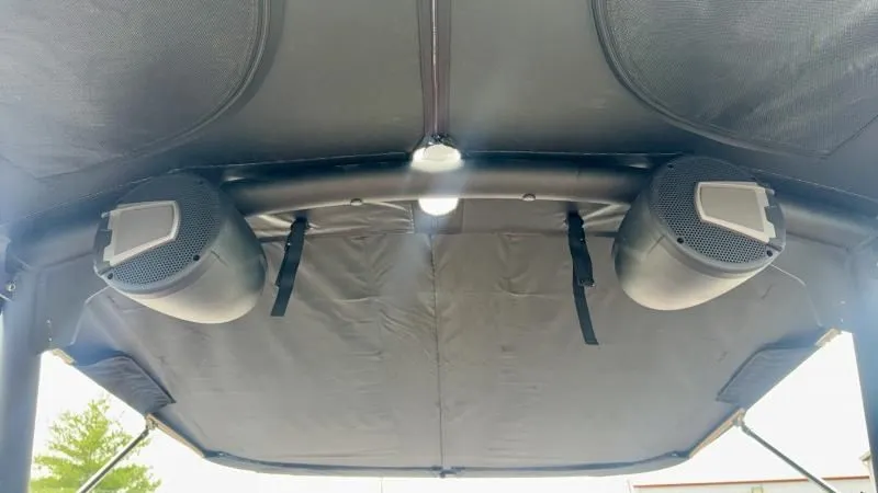 Slide: The Image of 2024 Axis A245 boat interior with mounted speakers and canopy. - 16