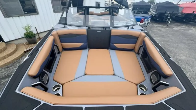 Slide: The Image of 2024 Axis A245 boat interior with tan and gray seating, cup holders, and modern design. - 8