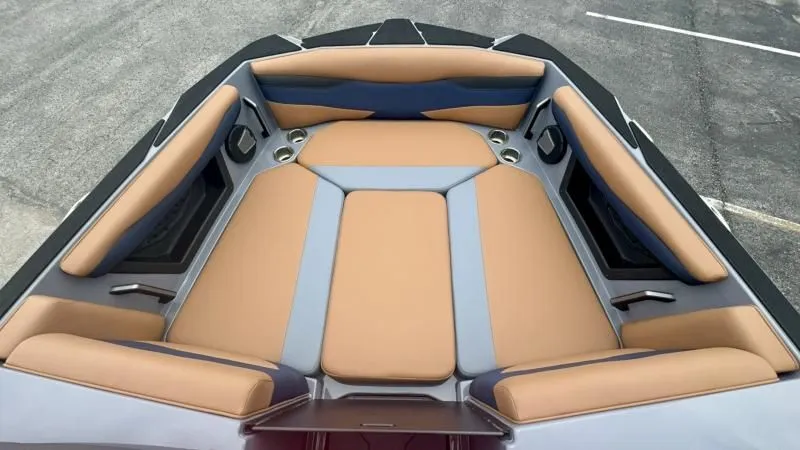 Slide: The Image of 2024 Axis A245 boat interior with tan and gray seating, cup holders, and sleek design. - 9