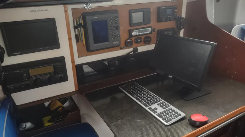 Slide: The Image of Navigation equipment and computer setup inside a 1980 Santa Cruz SC 50 sailboat. - 19
