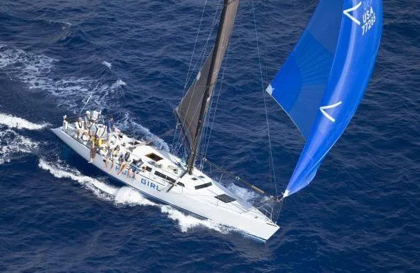 Slide: The Image of Aerial view of 1980 Santa Cruz SC 50 sailboat with blue spinnaker on open sea. - 2