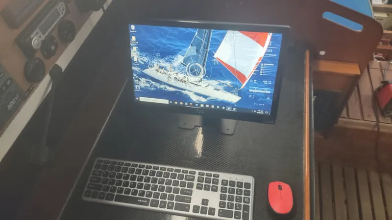 Slide: The Image of Computer setup on a Santa Cruz SC 50 yacht, featuring a monitor, keyboard, and red mouse. - 21