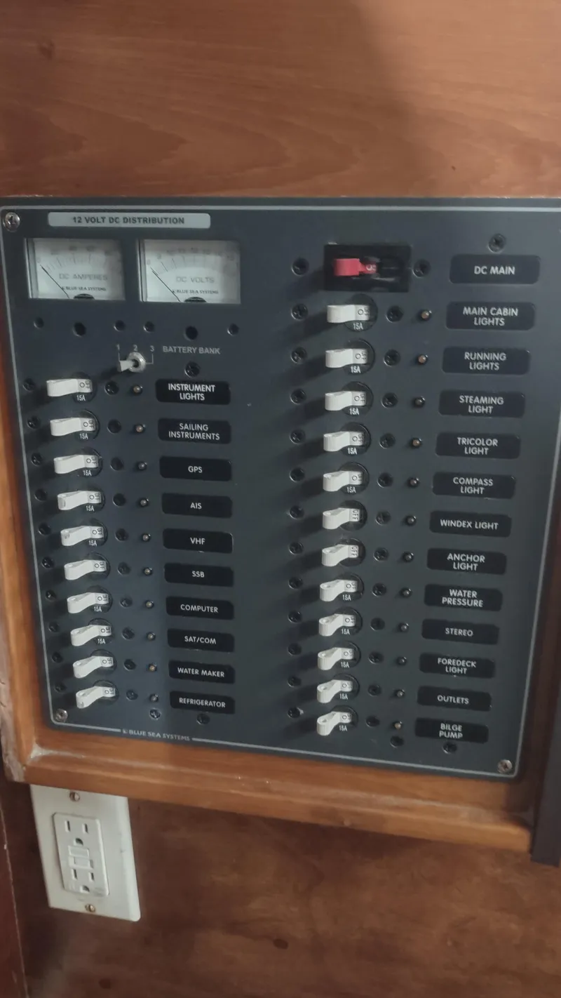 Slide: The Image of 1980 Santa Cruz SC 50 electrical panel with switches and meters for various boat systems. - 22