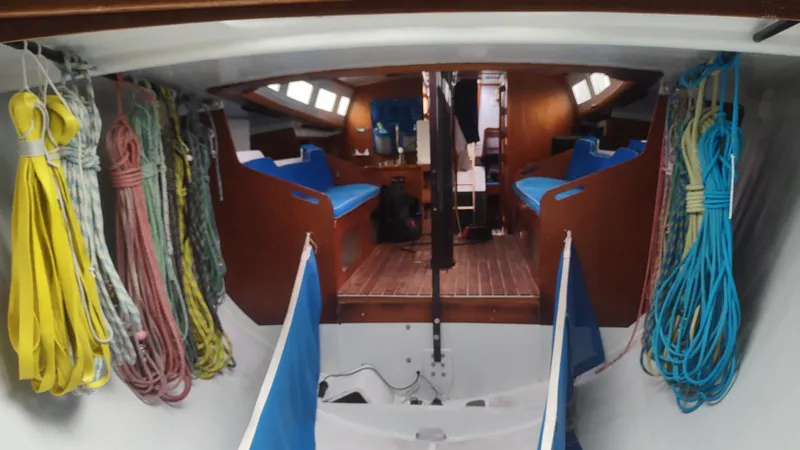 Slide: The Image of Interior of 1980 Santa Cruz SC 50 sailboat with ropes and wooden seating. - 27