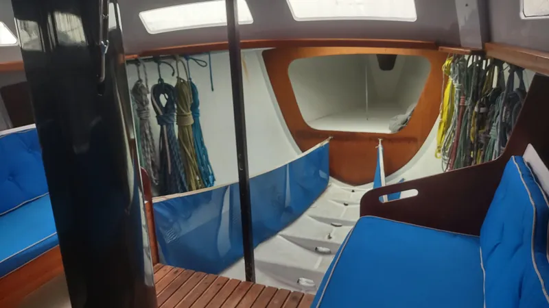 Slide: The Image of Interior of a 1980 Santa Cruz SC 50 sailboat with blue cushions and ropes. - 29