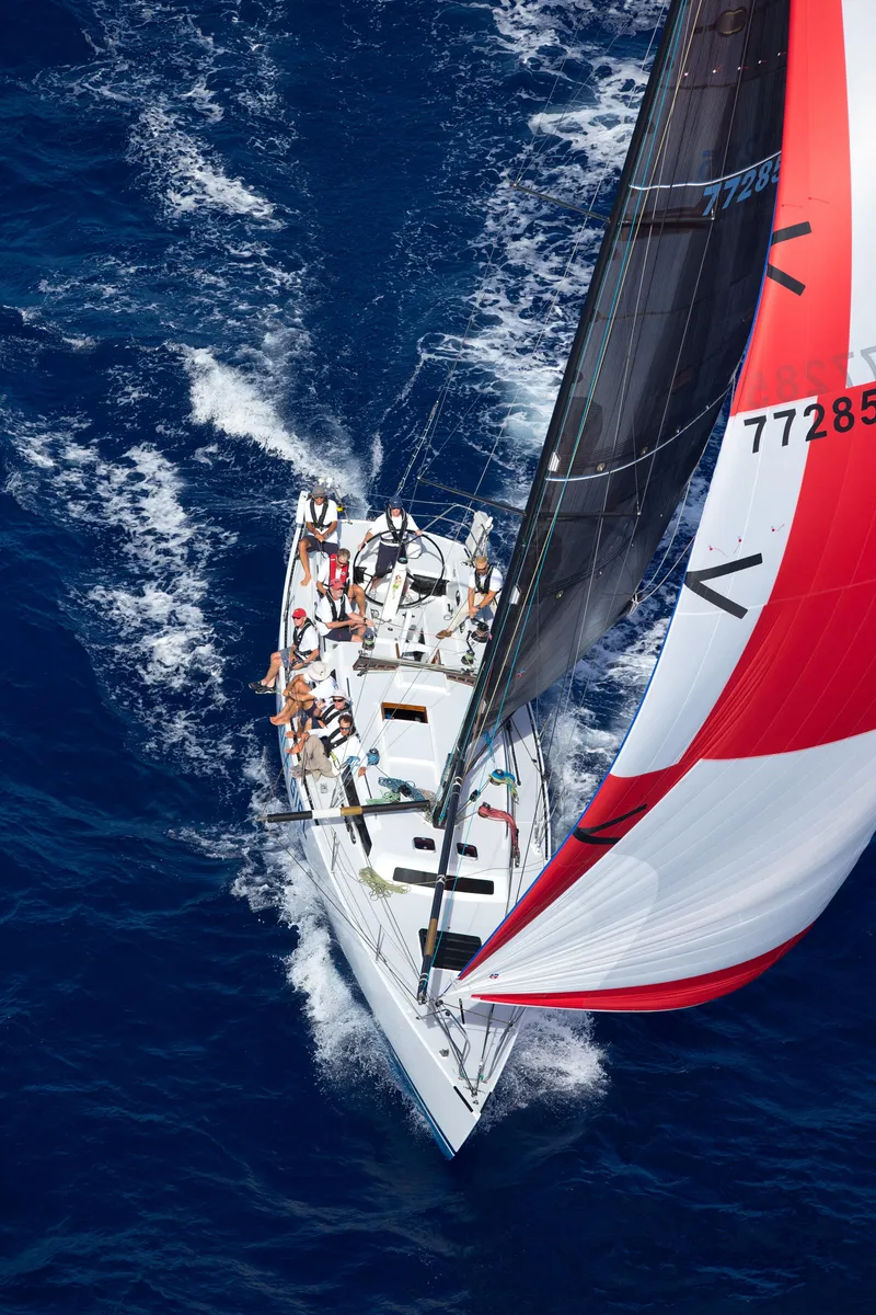 Slide: The Image of Aerial view of 1980 Santa Cruz SC 50 sailboat racing on open blue sea. - 3