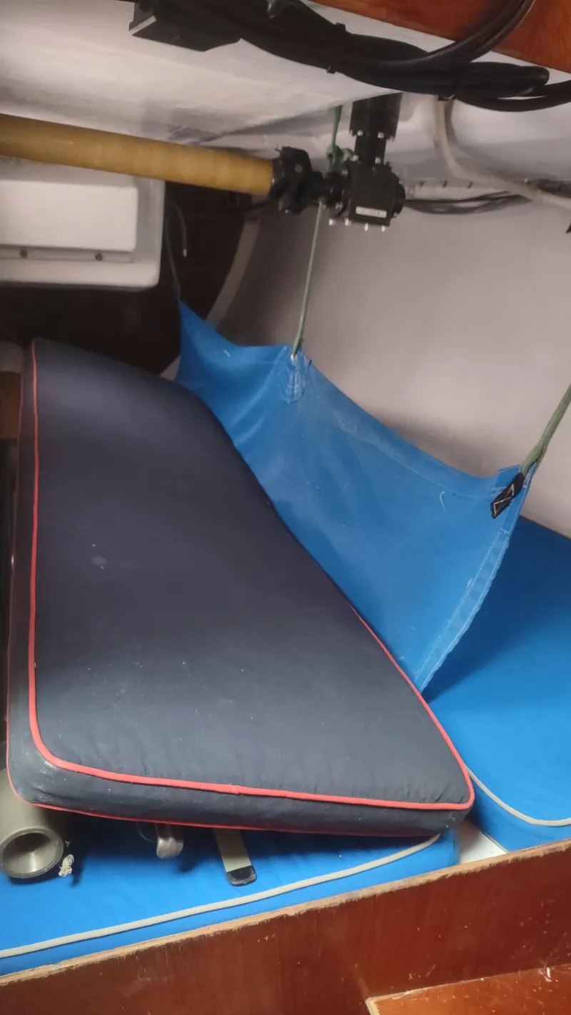 Slide: The Image of Interior of a 1980 Santa Cruz SC 50 sailboat with blue and black cushions. - 33