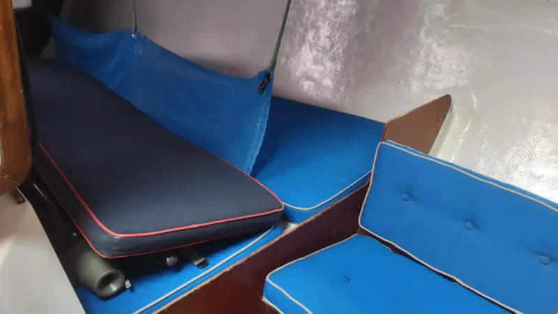 Slide: The Image of Interior of 1980 Santa Cruz SC 50 sailboat with blue cushions and wooden accents. - 34