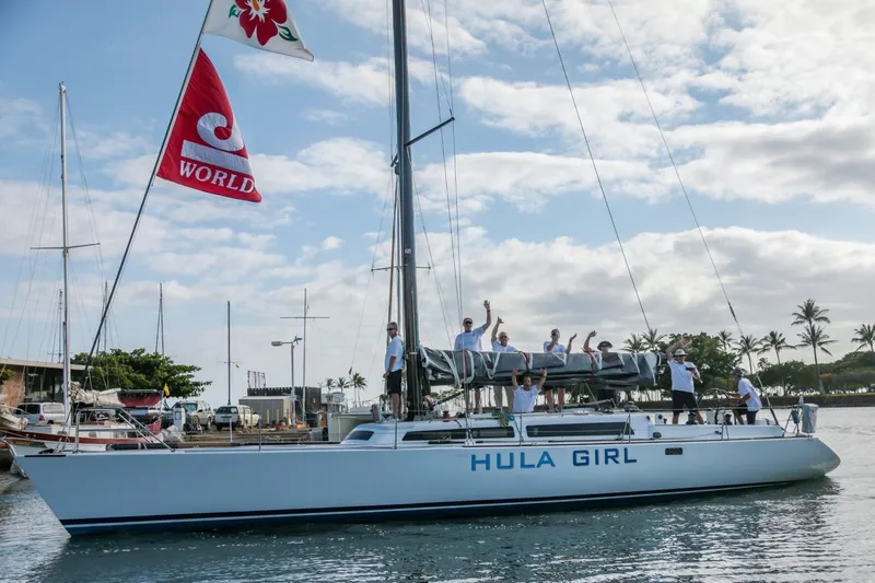 Slide: The Image of Sailboat "Hula Girl" Santa Cruz SC 50, 1980, with crew waving, docked under cloudy sky. - 4