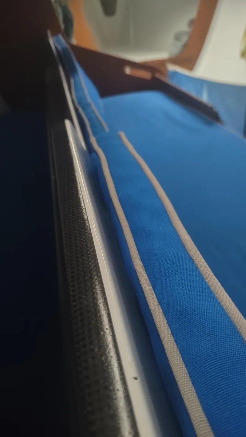 Slide: The Image of Interior view of a 1980 Santa Cruz SC 50 sailboat with blue fabric details. - 40