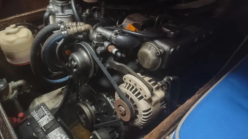 Slide: The Image of Engine compartment of a 1980 Santa Cruz SC 50 with visible alternator and battery. - 43