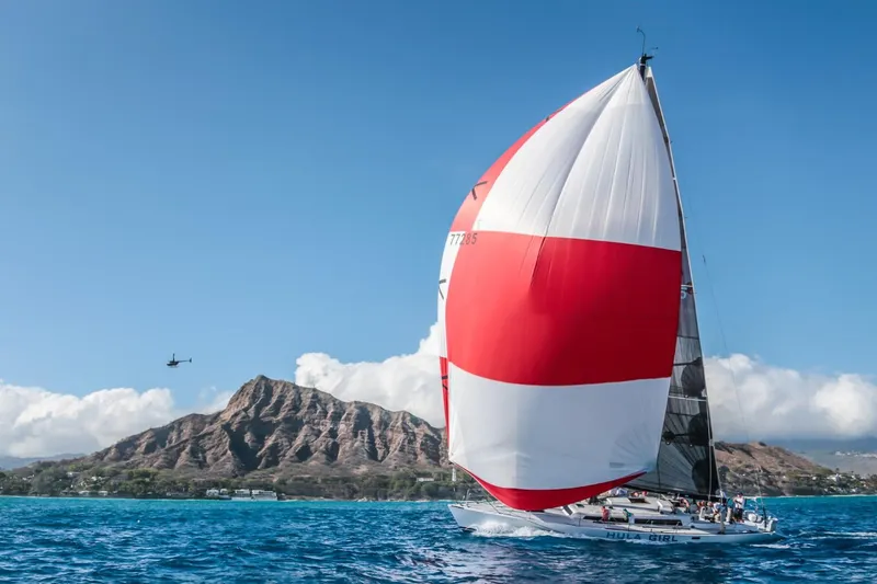 Slide: The Image of Sailboat "Hula Girl" with red and white spinnaker near mountain, Santa Cruz SC 50, 1980. - 9