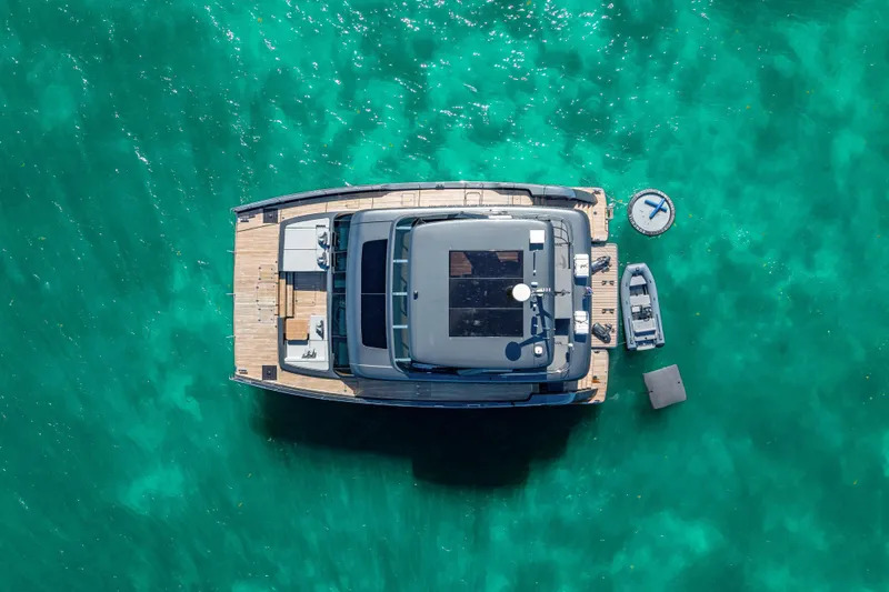 Slide: The Image of Aerial view of 2026 Sunreef 60 Power yacht on turquoise water. - 12