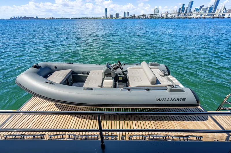 Slide: The Image of Luxury yacht Sunreef 60 Power 2026 with Williams tender on deck, overlooking city skyline. - 16