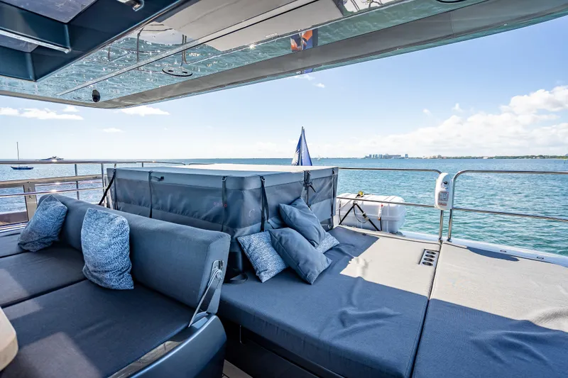 Slide: The Image of Luxurious Sunreef 60 Power yacht deck with comfortable seating, ocean view, and clear skies. - 22