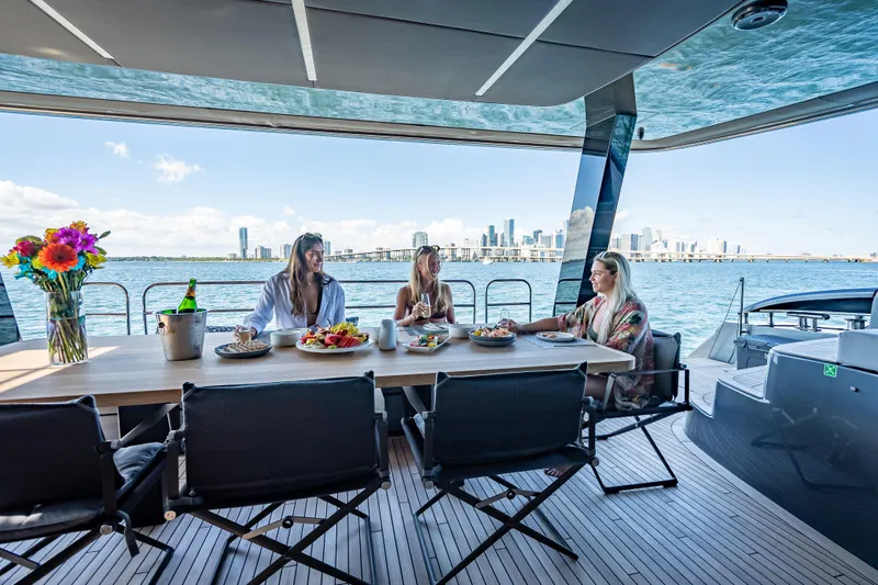 Slide: The Image of Luxury dining on 2026 Sunreef 60 Power yacht with city skyline view. - 32