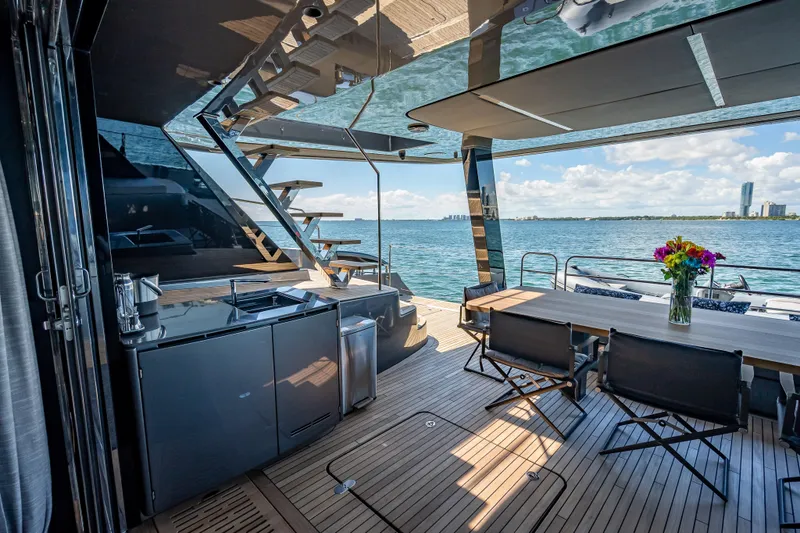 Slide: The Image of Luxurious Sunreef 60 Power yacht deck with modern kitchen and dining area, overlooking the ocean. - 38