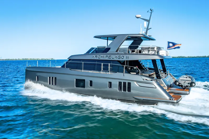 Slide: The Image of 2026 Sunreef 60 Power yacht cruising on blue ocean waters. - 6