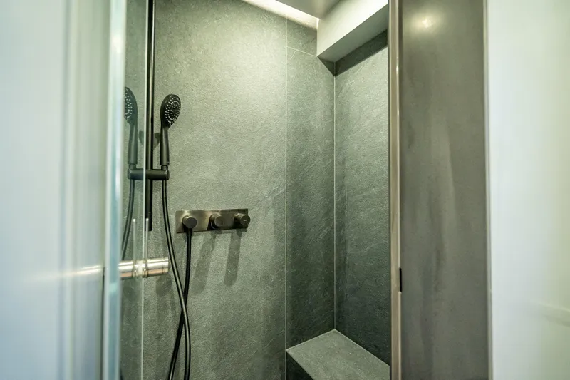 Slide: The Image of Modern shower in 2026 Sunreef 60 Power yacht, featuring sleek design and dark tiles. - 76