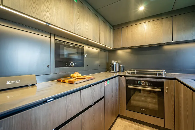 Slide: The Image of Modern kitchen interior on 2026 Sunreef 60 Power yacht, featuring sleek cabinetry and appliances. - 77
