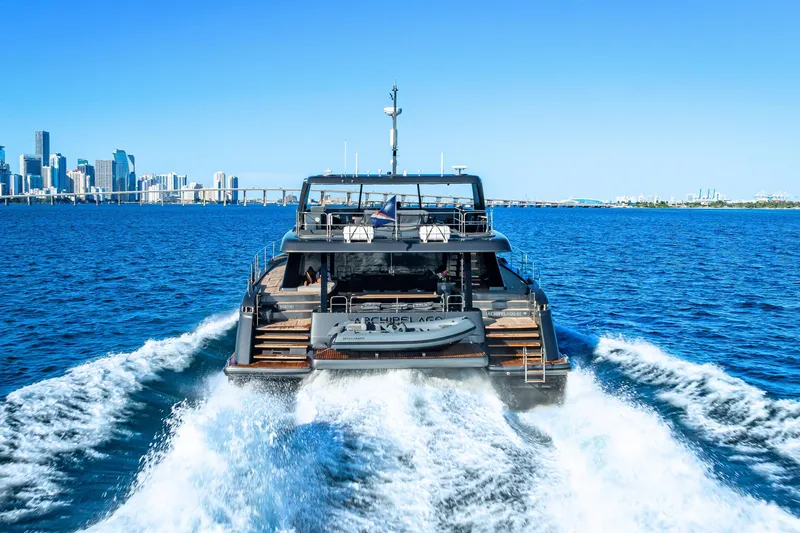 Slide: The Image of Sunreef 60 Power yacht cruising near city skyline, 2026 model. - 8