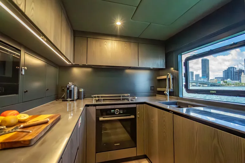Slide: The Image of Luxurious kitchen interior of 2026 Sunreef 60 Power yacht with cityscape view. - 80