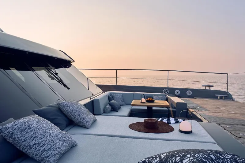 Slide: The Image of Luxurious Sunreef 60 Power yacht deck with elegant seating, cushions, and ocean view at sunset. - 81