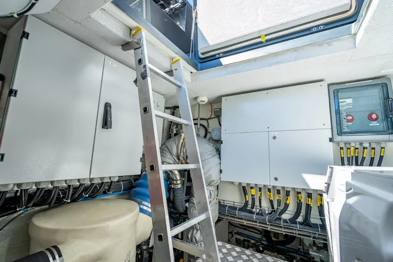 Slide: The Image of Engine room of 2026 Sunreef 60 Power yacht with control panels and ladder. - 84