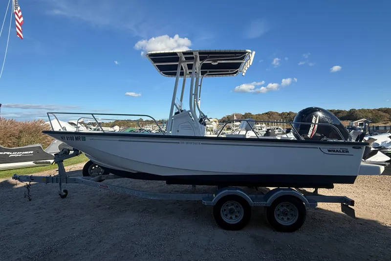 The Image of 2021 Boston Whaler 190 Montauk boat on trailer under clear blue sky. - 0