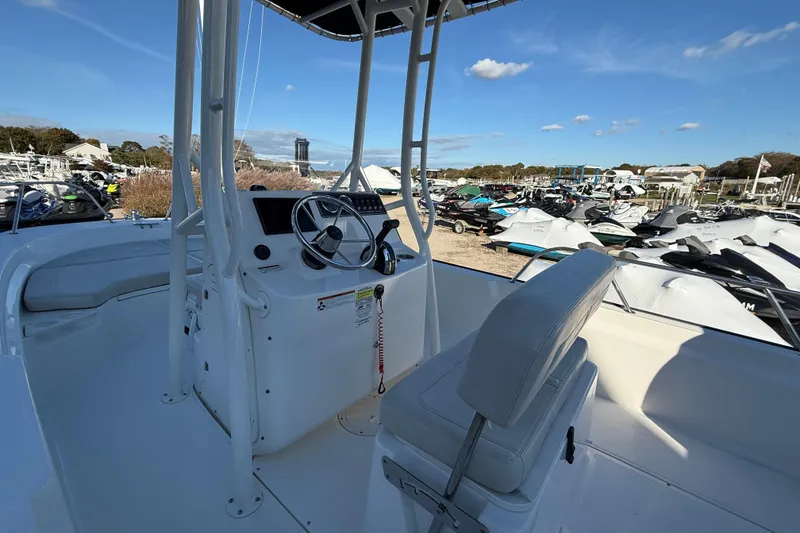 Slide: The Image of 2021 Boston Whaler 190 Montauk boat interior with steering console and seating. - 11
