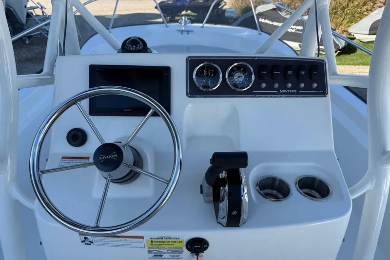 Slide: The Image of 2021 Boston Whaler 190 Montauk boat console with steering wheel and controls. - 14