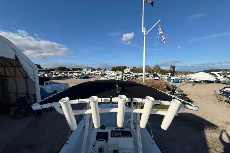 Slide: The Image of 2021 Boston Whaler 190 Montauk boat in a marina with clear blue sky. - 15