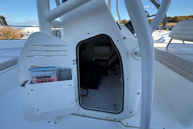 Slide: The Image of 2021 Boston Whaler 190 Montauk boat storage compartment with distress flag visible. - 18