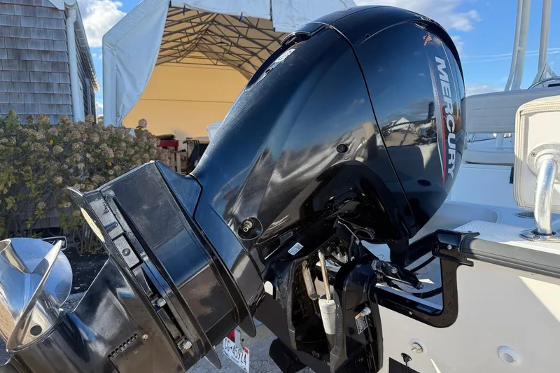 Slide: The Image of 2021 Boston Whaler 190 Montauk with Mercury outboard motor, docked outdoors. - 2