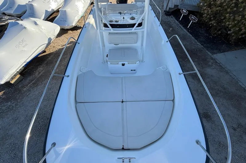 Slide: The Image of 2021 Boston Whaler 190 Montauk boat interior with cushioned seating and console. - 21