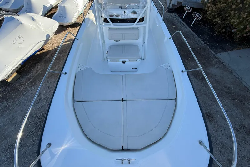 Slide: The Image of 2021 Boston Whaler 190 Montauk boat interior with cushioned seating and console. - 22