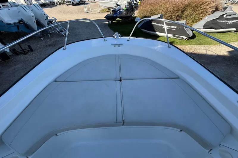 Slide: The Image of 2021 Boston Whaler 190 Montauk boat interior with cushioned seating and railings. - 23