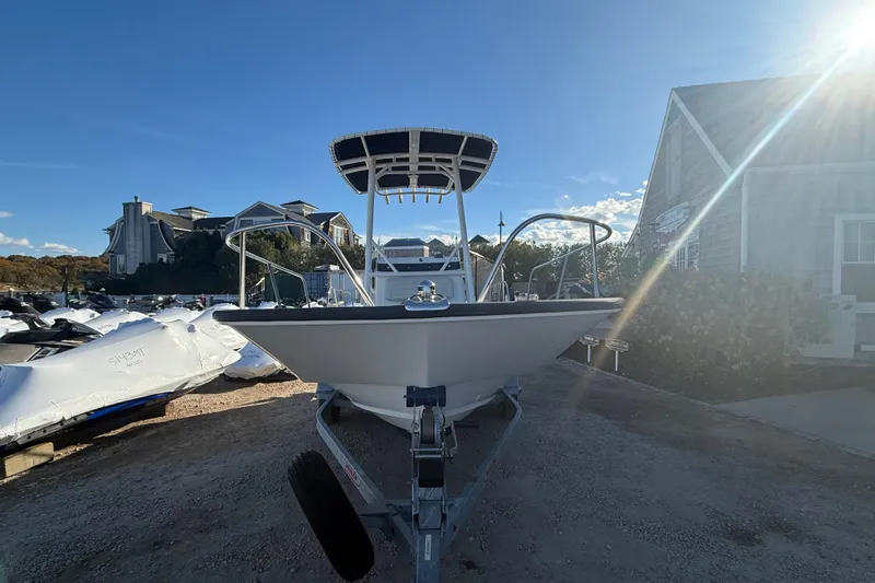 Slide: The Image of 2021 Boston Whaler 190 Montauk boat on trailer, sunny day, residential background. - 24