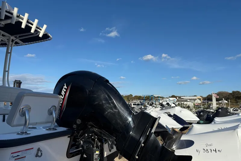 Slide: The Image of 2021 Boston Whaler 190 Montauk with Mercury engine, docked under clear blue sky. - 3