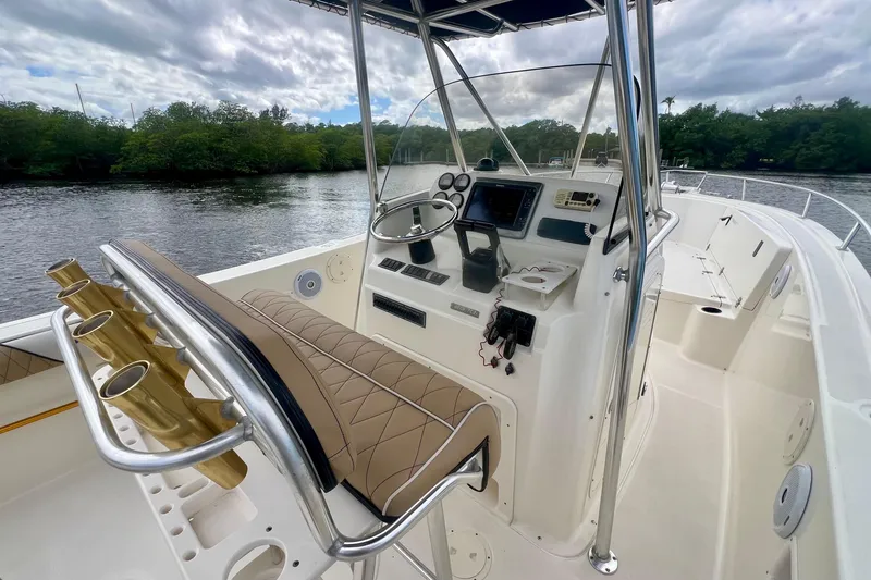 Slide: The Image of 2005 Pursuit 2670 Center Console boat interior with helm, seating, and rod holders. - 11