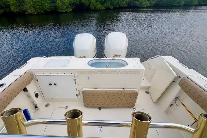 Slide: The Image of 2005 Pursuit 2670 Center Console boat with twin Yamaha 225 engines on a calm river. - 13