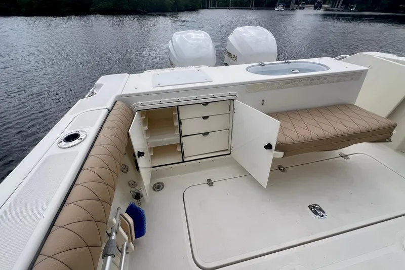 Slide: The Image of 2005 Pursuit 2670 Center Console boat interior with storage and seating. - 14