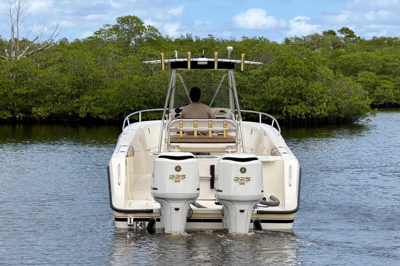 Slide: The Image of 2005 Pursuit 2670 Center Console boat with dual engines on calm water. - 3