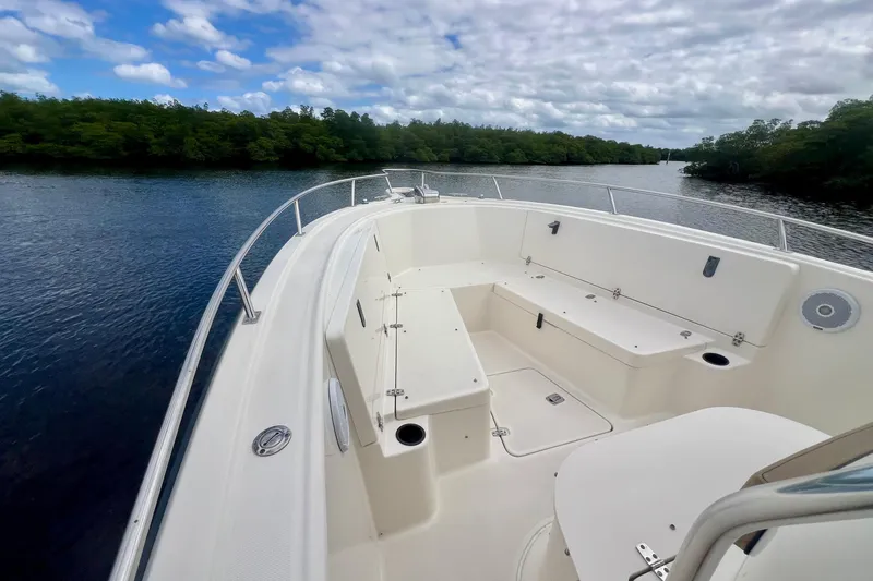 Slide: The Image of 2005 Pursuit 2670 Center Console boat on calm water under cloudy sky. - 6
