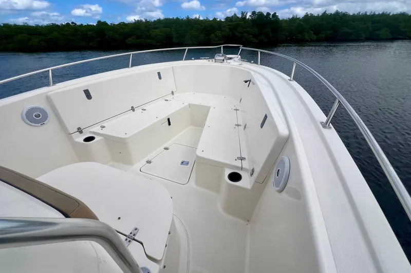 Slide: The Image of 2005 Pursuit 2670 Center Console boat interior with seating, on calm water. - 7